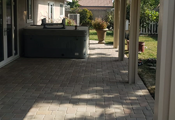Modern backyard in Burbank with newly installed patio cover and paved patio.